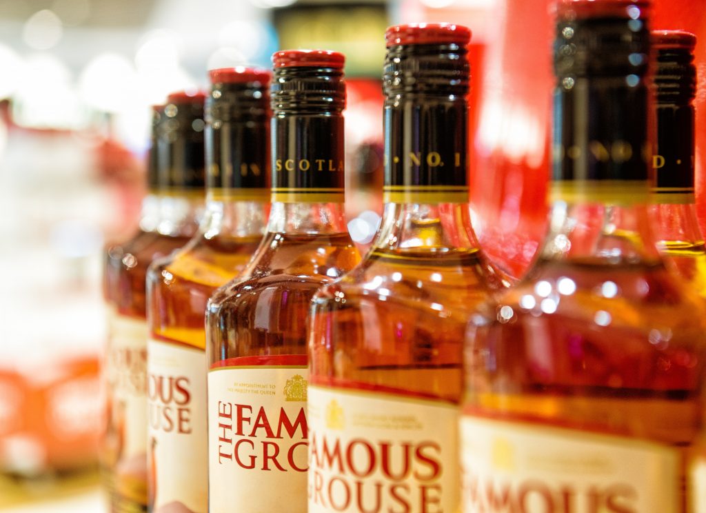 Row of bottles of THE FAMOUS GROUSE Scottish Whiskey